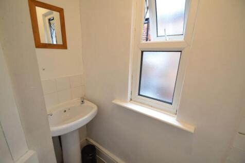 Compact and clean single toilet featuring a whi...