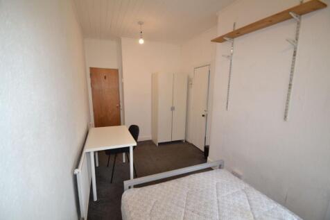A compact single bedroom featuring a simple des...