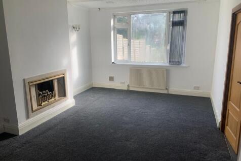 A bright and spacious living room featuring a l...