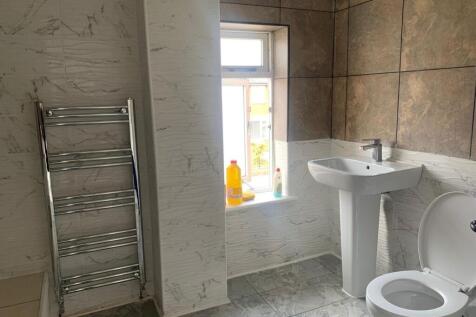 A bright and clean bathroom featuring modern ti...