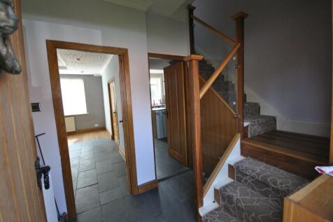 A clean and well-maintained hallway featuring a...