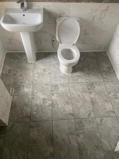 Bright and clean single toilet with modern pede...