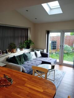 A bright and inviting living room featuring a c...
