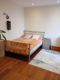 Bright and tidy double bedroom featuring a comf...
