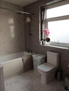 A clean and modern bathroom suite featuring a b...