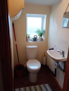 A neat and well-maintained small toilet room fe...
