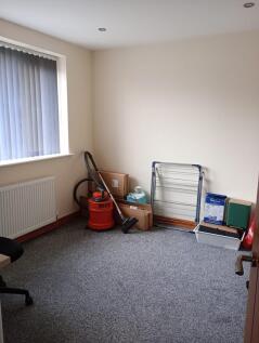 A simple, clean single bedroom with a large win...