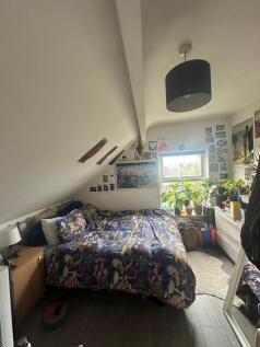 A cozy and charming double bedroom featuring a ...