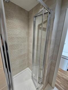 A modern bathroom with a sleek glass shower enc...