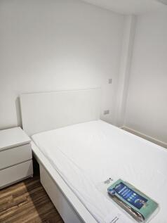 A clean and simple single bedroom featuring a w...