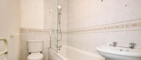 A clean, functional bathroom featuring a bathtu...