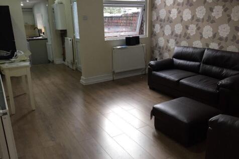 A cozy living room featuring a dark leather sof...