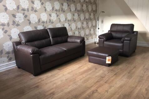 A modern living room featuring a brown leather ...