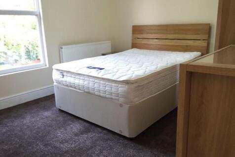 Bright double bedroom featuring a comfortable d...