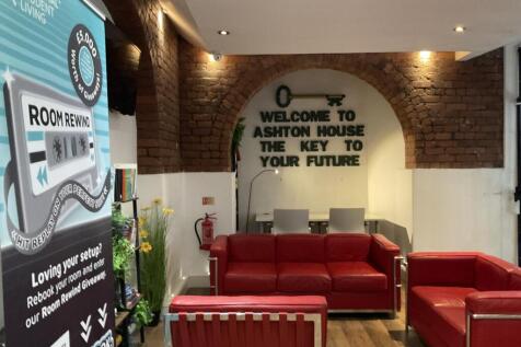 A cozy communal lounge with exposed brick walls...