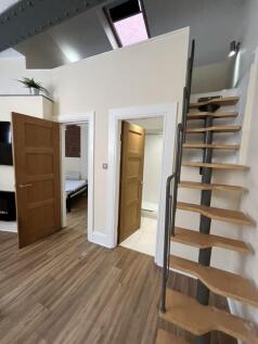 Bright and modern room featuring a sleek wooden...