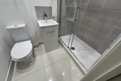 A modern, pristine bathroom suite featuring a s...