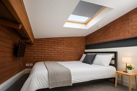A cozy double bedroom featuring a comfortable d...