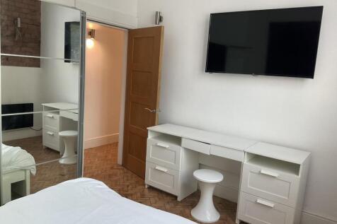 Bright and tidy double bedroom featuring a larg...