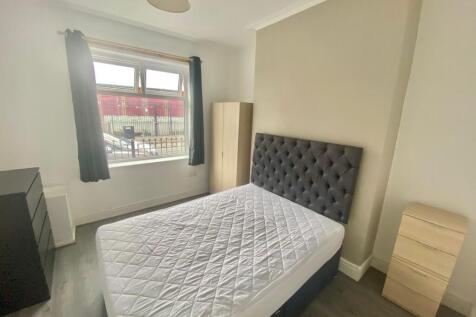 Bright double bedroom with a large window provi...