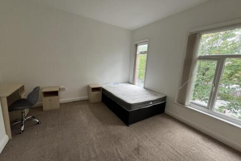 A bright and spacious double bedroom featuring ...