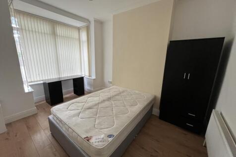 Bright and cozy single bedroom featuring a larg...