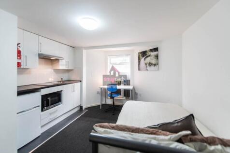 Bright and modern living room featuring a compa...