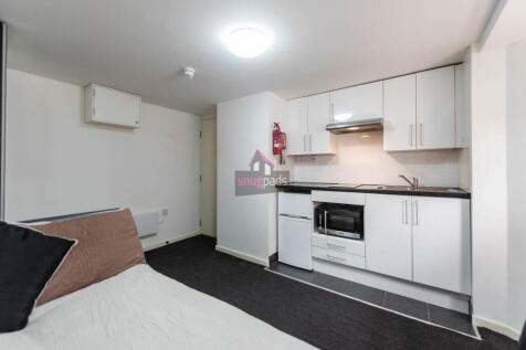 Bright and tidy compact kitchen featuring moder...