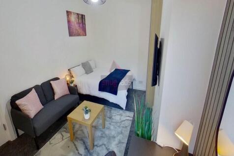 A clean and well-lit single toilet room with mo...