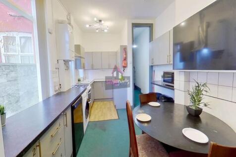 Bright and modern kitchen featuring a large win...