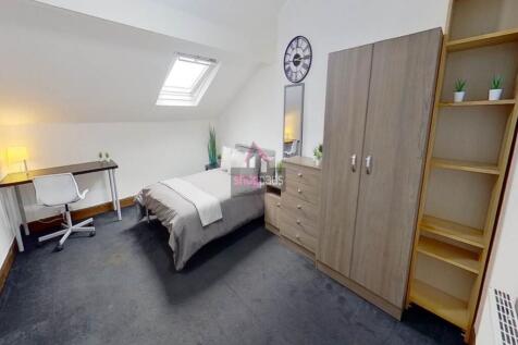 Bright and cozy bedroom featuring a single bed,...