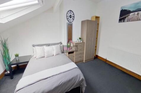 Bright and cozy bedroom featuring a comfortable...