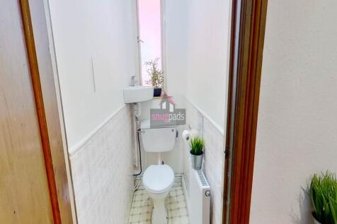 Bright and clean single toilet space featuring ...