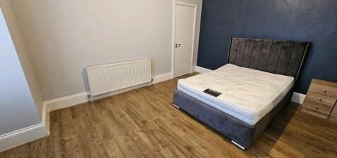 A spacious master bedroom featuring a modern da...