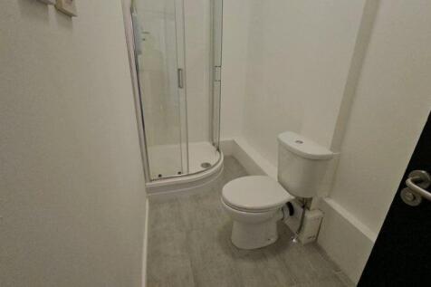 A clean and modern bathroom featuring a compact...
