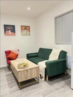 A cozy living room featuring a stylish dark gre...