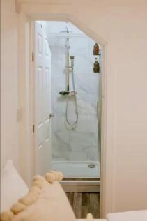 Bright and clean bathroom featuring a modern wa...
