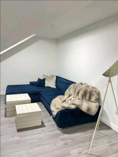 Contemporary living room featuring a stylish de...