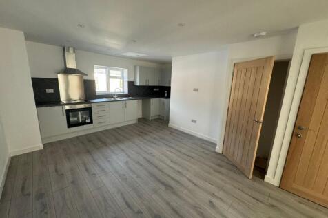 Bright and modern kitchen with sleek white cabi...