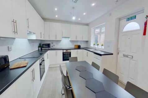 Bright and modern kitchen featuring ample white...