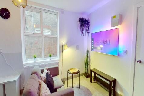 A stylish and cozy living room featuring a comf...