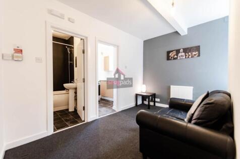 A cozy living room featuring modern dark leathe...