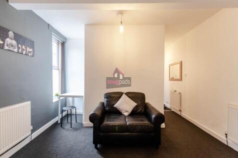 A cozy living room featuring a comfortable blac...