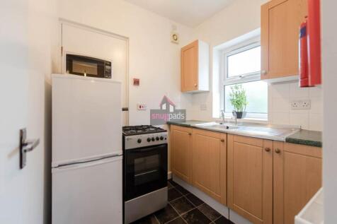 A neat and functional kitchen featuring wooden ...
