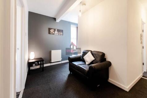 A cozy living room featuring a comfortable blac...
