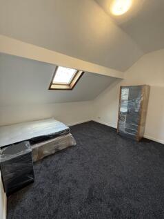 A cozy attic bedroom featuring a skylight windo...