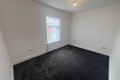 A bright and clean living room with a large win...
