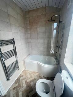 Modern bathroom featuring a large bathtub with ...