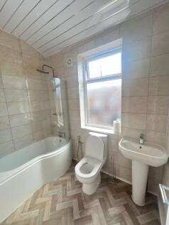 Bright and modern bathroom featuring a large ba...
