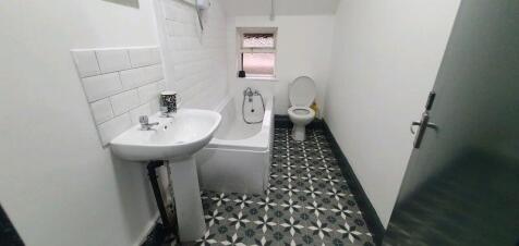 A clean and well-maintained bathroom with a whi...